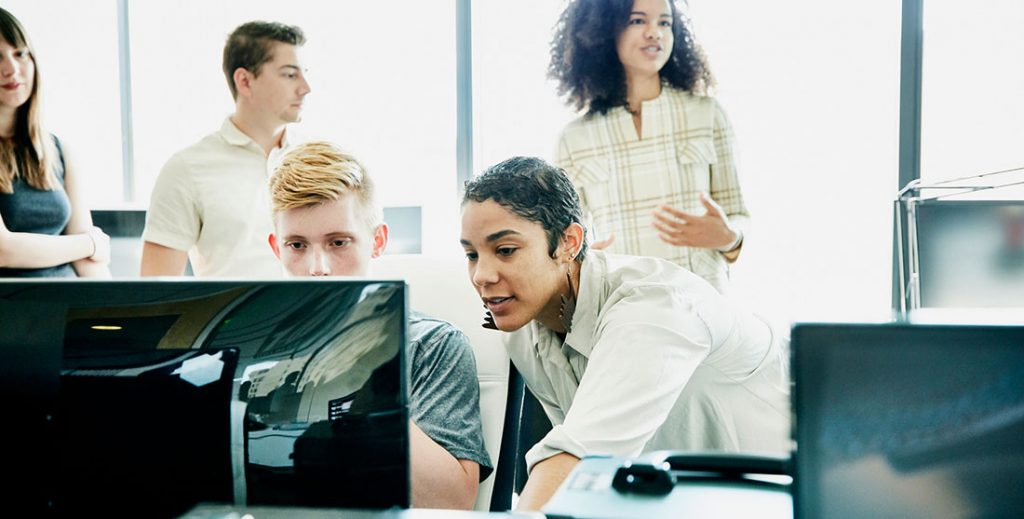 5 Mistakes Your Internal Marketing Team Are Making Image woman leaning over desk